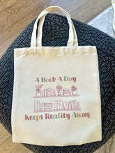 Load image into Gallery viewer, A Book A Day Keeps Reality Away Tote Bag 14” x 16”
