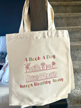 Load image into Gallery viewer, A Book A Day Keeps Reality Away Tote Bag 14” x 16”
