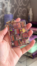 Load and play video in Gallery viewer, The Cozy Cottage Bookshelf Acrylic Holographic Keychain
